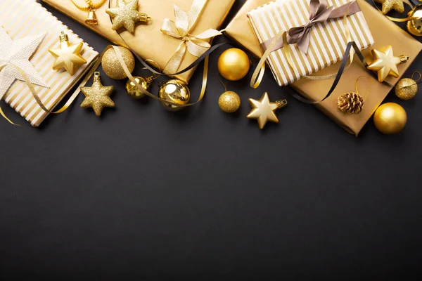güzel Noel altın baubles hediyeler ile üstten görünüm koyu siyah arka plan üzerine