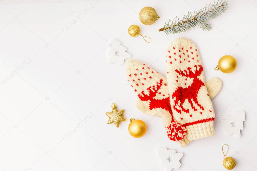 top view of golden decorative elements for christmas with gloves on white tabletop
