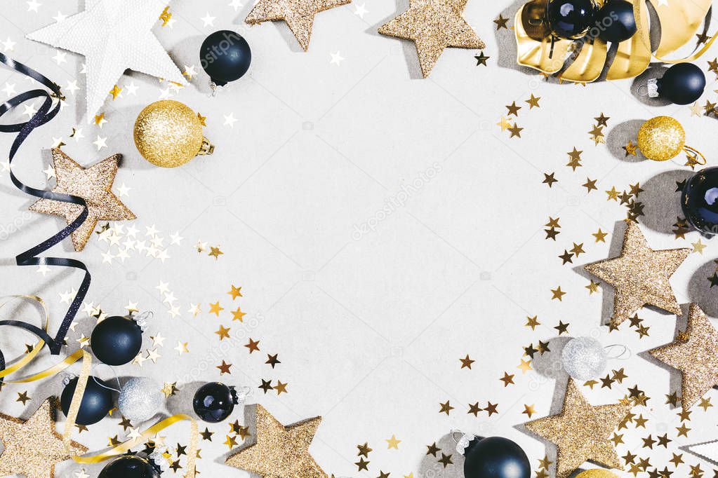 top view of Beautiful christmas black, golden and silver decorative baubles on white background