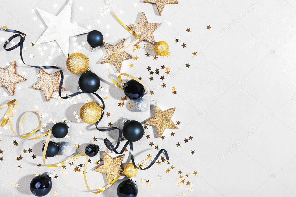 flat lay of Beautiful christmas black, golden and silver decorative baubles on white background