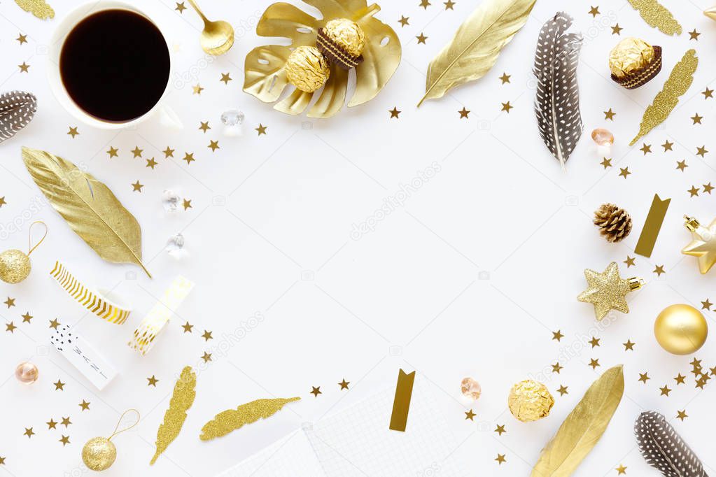top view of golden decorative elements for christmas with coffee on white tabletop