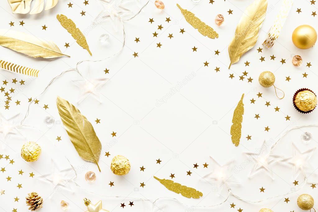 top view of golden decorative elements for christmas on white tabletop