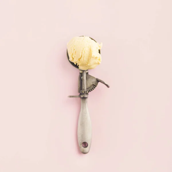 Vanilla ice cream in vintage old ice cream spoon on faded violet background