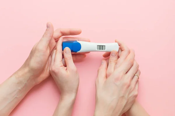 Wife and husband holding in hands pregnancy test — Stock Photo, Image