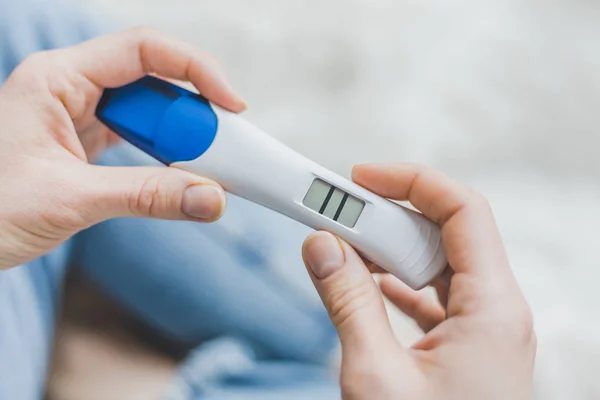 Woman looking on positive pregancy test — Stock Photo, Image