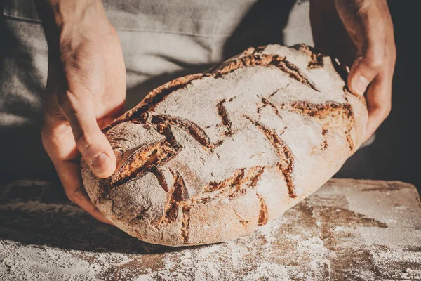 Baker, vagy szakács gazdaság friss kenyérrel — Stock Fotó