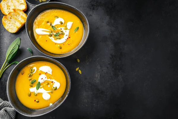 Pumpkin creamy soup served in bowls — Stock Photo, Image