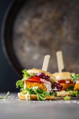Burger with chicken patty and vegetables