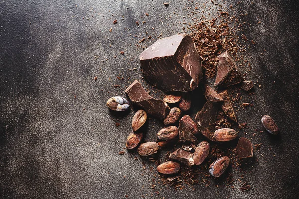 Closeup Dark Chocolate Chunks Beans Table — Stock Photo, Image
