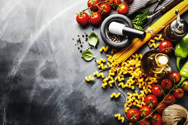 Italian food background with ingredients for cooking on dark background. View from above. Cooking concept. 