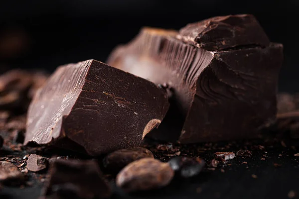Closeup of dark chocolate chunks on table.