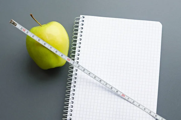 Blank notebook with apple and measuring tape Stock Photo