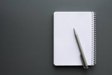 Boş kalemle gri ofis resepsiyon arka plan üzerinde beyaz dizüstü açtı. Üstten görünüm, kopya alanı.