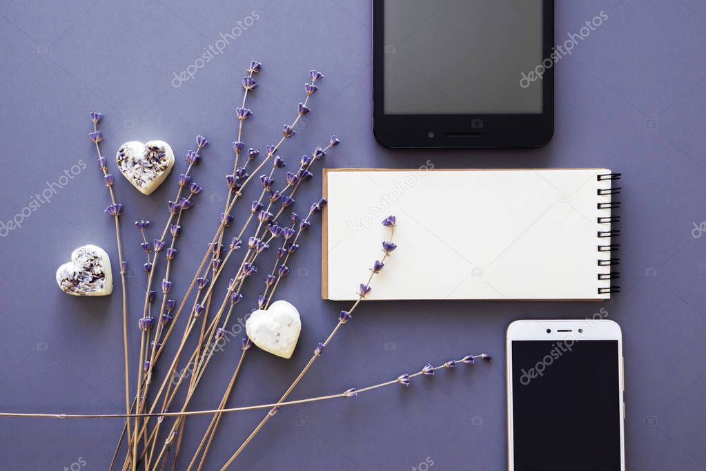 blank noteboook, gadgets and lavender flowers flatlay