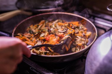 Dilimlenmiş sebzeler tavada. Sebze Güveç.