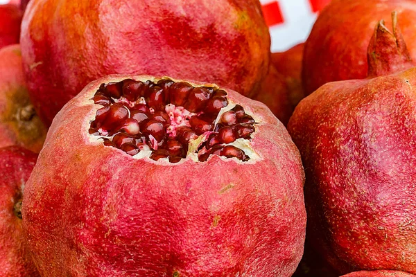 Pomegranate fruit with red fruits. Fruit on the counter. Healthy fruit.