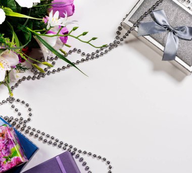 Mesaj için ayrılmış bir tebrik kartı için arka plan. Beyaz bir arkaplanda, bir bardak şarap, hediye kutuları ve çiçekler..