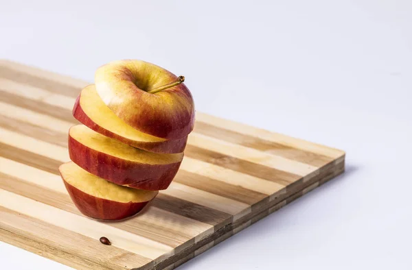 Apple sliced into slices on a chopping Board