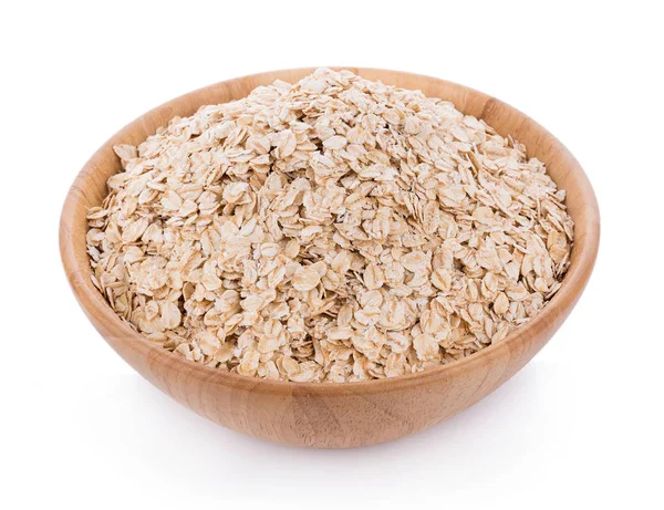 Oat flakes pile in wooden bowl on white — Stock Photo, Image