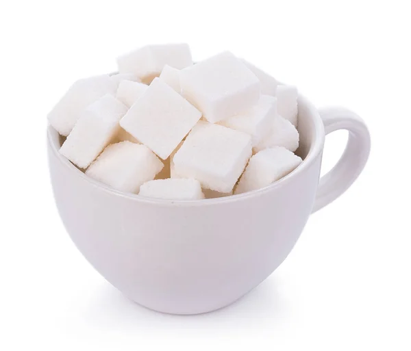 Cubo de azúcar en taza sobre fondo blanco — Foto de Stock