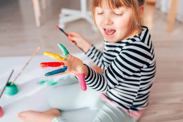 little girl painting hand