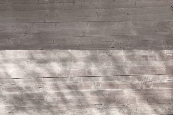 Sombra de follaje en una pared de madera gris. Hermoso fondo de sombra — Foto de Stock