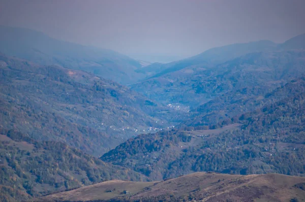 Mountains in a blue haze in autumn afternoon