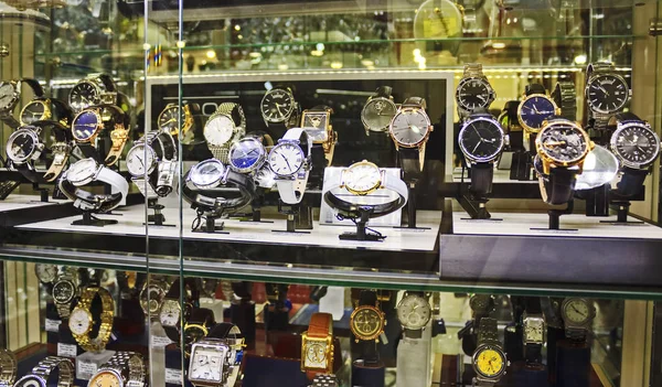 Showcase with wrist watches. Collection of expensive luxury watches from gold, silver and leather