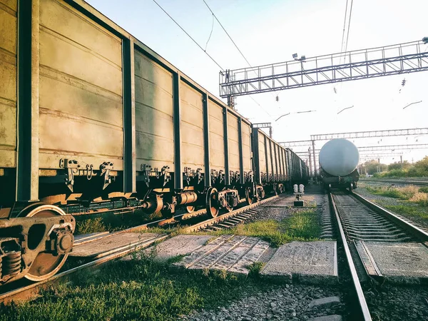 Perspective view of industrial train wagons and oil cistern on railway station