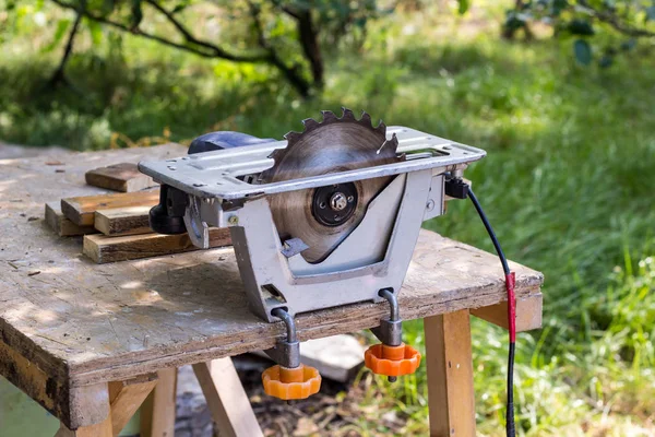 Electric saw table tool for woodwork with free space. Workshop with nobody