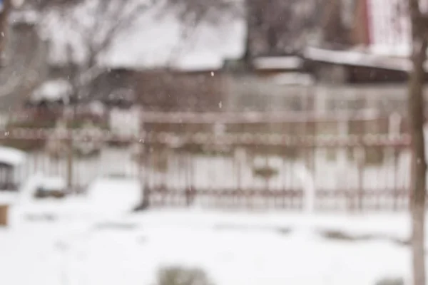 blurred background snow winter village small houses and trees.