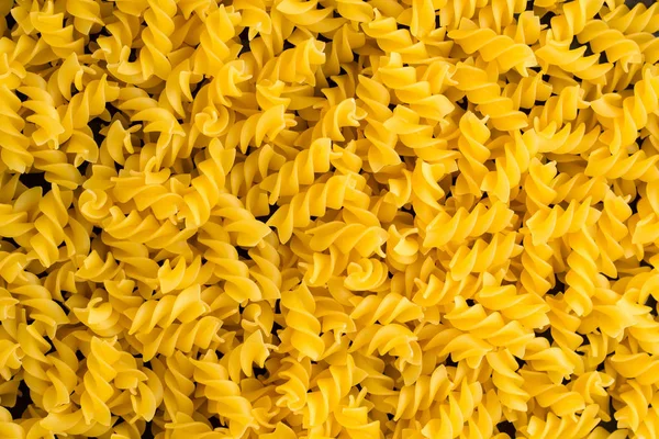 Hintergrund eines Haufens Nudelspirale fusilli — Stockfoto