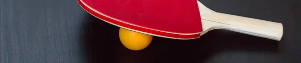 Banner of table tennis or ping pong racket and ball on a black background — Stock Photo, Image