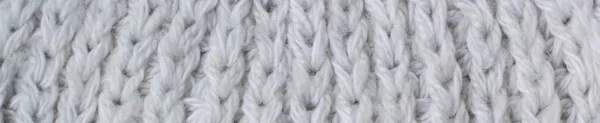 Πανό του πουλόβερ ή κασκόλ μοτίβο του λευκού πλεκτό ύφασμα υφή φόντο — Φωτογραφία Αρχείου