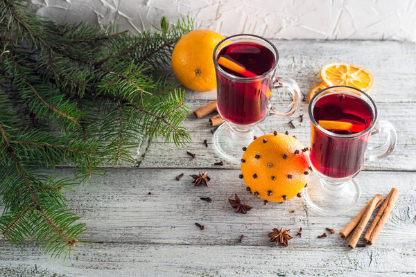 christmas hot mulled wine with cinnamon orange and anise on white wooden background