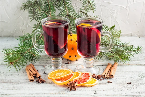 Christmas hot mulled wine with cinnamon orange and anise on white wooden background — Stock Photo, Image