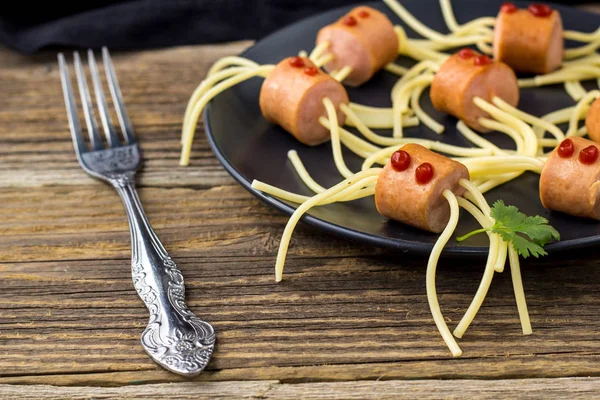 Спагетти с сосисками в виде пауков. Счастливая детская еда для Хэллоуина . — стоковое фото