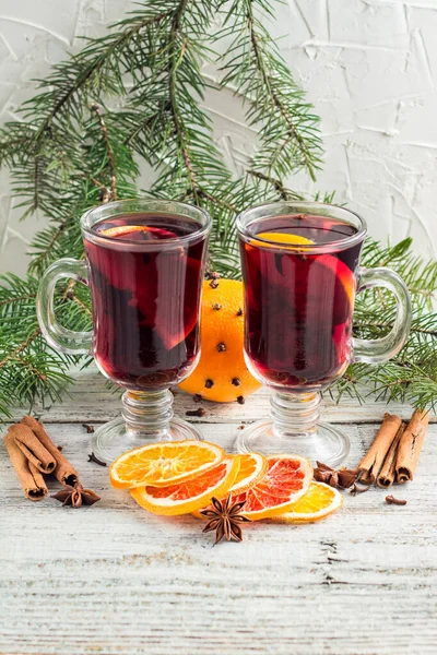 Christmas hot mulled wine with cinnamon orange and anise on white wooden background — Stock Photo, Image