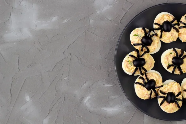 Deviled Eggs With A Spider For Halloween Party. Fun food for kids. Top view with copy space