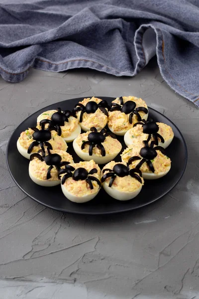 Deviled Eggs With A Spider For Halloween Party. Fun food for kids with napkin. Copy space