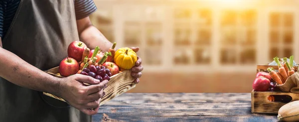 Fall harvest cornucopia. Farmer with fruit and vegetable in Autumn season. Thanksgiving day concept.