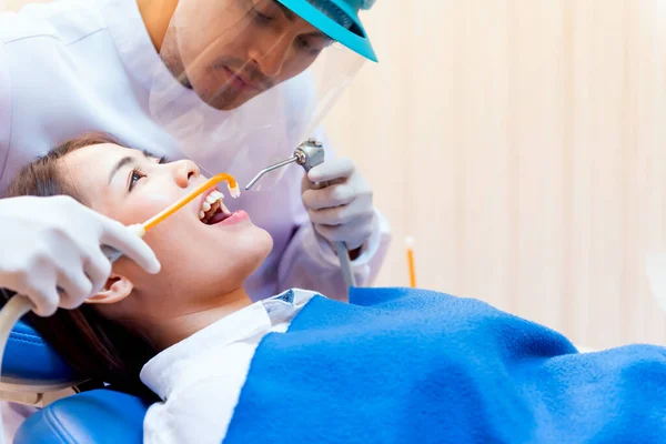 Dentistry and healthcare concept at dental clinic. Dentist check-up teeth for young asian patient.