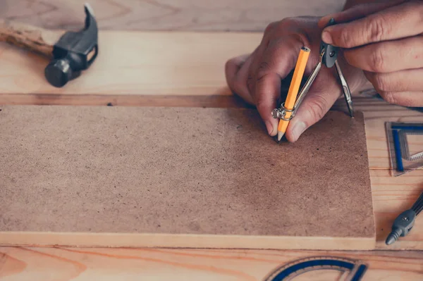 Carpenter working in carpentry shop. Woodwork for furniture and home decor making concept. DIY wood for decoration.