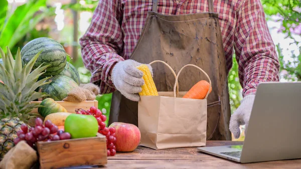 Farmer sell fresh fruit online. Online shopping and home delivery concept. New normal life and business after COVID-19. Lock down and Self-quarantine.