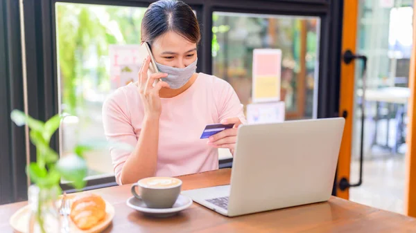 Asian woman wear face mask and online shopping. Social distancing and New normal lifestyle.