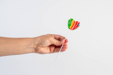 Sweets, lollipops in hand, on white background