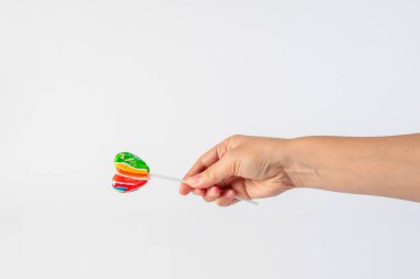 Sweets, lollipops in hand, on white background