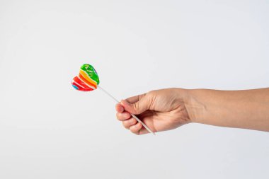 Sweets, lollipops in hand, on white background