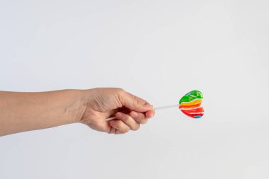 Sweets, lollipops in hand, on white background