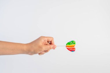 Sweets, lollipops in hand, on white background